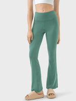 Green leggings worn by a person on a white background