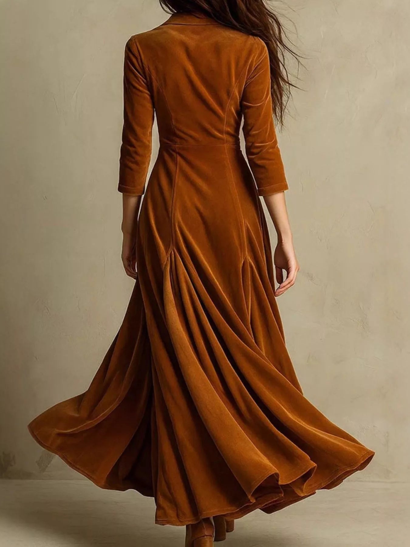 Brown velvet dress with long sleeves on a plain background