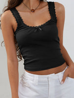 Black tank top with lace details worn by a person against a neutral background