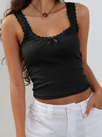 Black tank top with lace details worn by a person against a neutral background