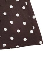 Close-up of a brown fabric with white polka dots