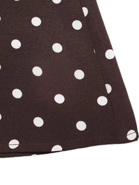 Close-up of a brown fabric with white polka dots