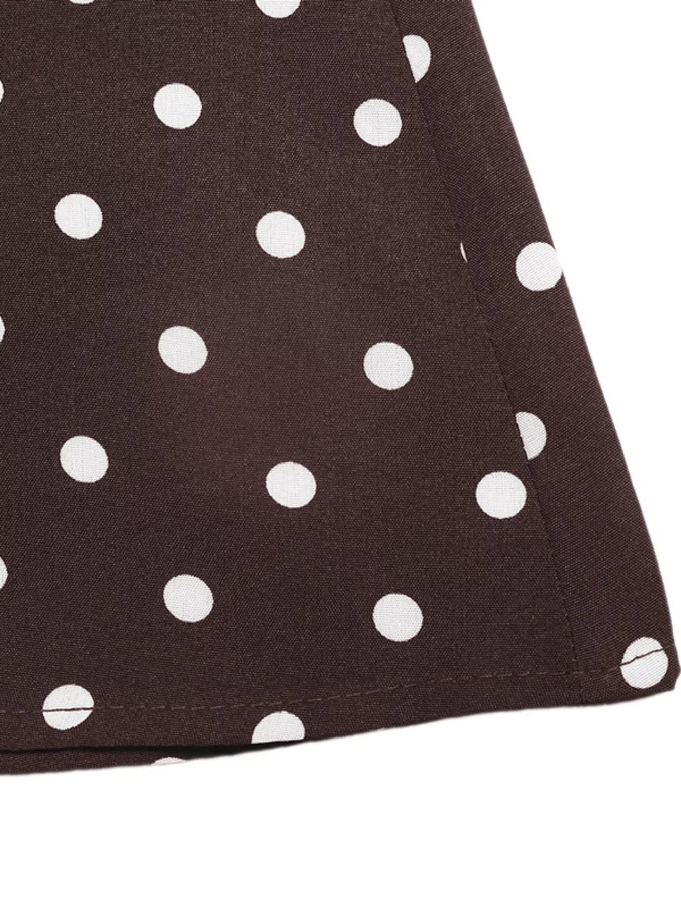 Close-up of a brown fabric with white polka dots
