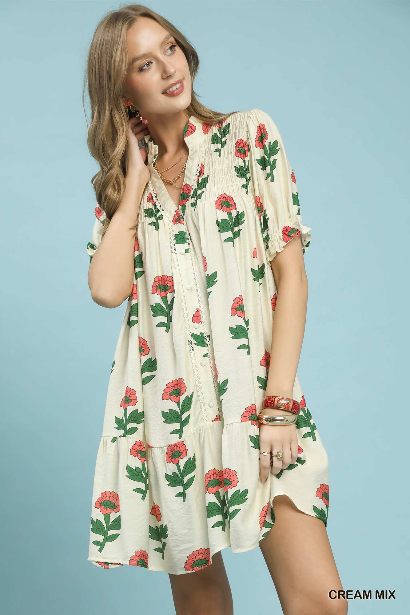 Woman wearing a floral dress against a light blue background