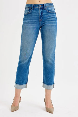 Blue jeans with a cuffed hem on a white background