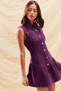Woman wearing a purple dress against a beige background
