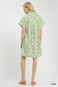 Woman wearing a green patterned dress on a white background