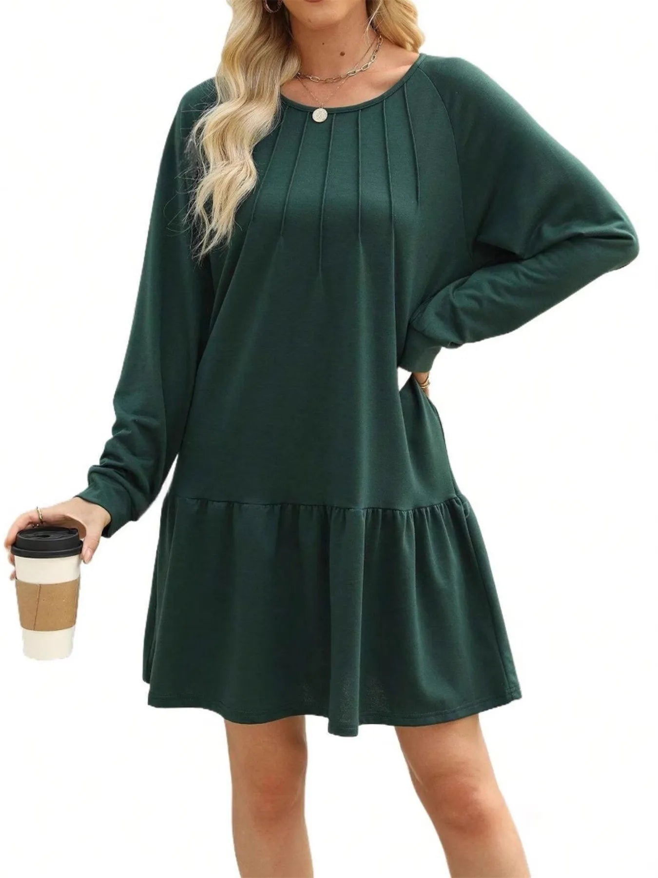 Green dress worn by a person on a white background