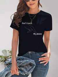 Person wearing a black t-shirt with 'Don't touch my phone' text design.
