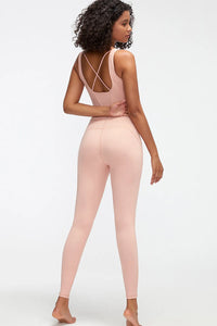 Woman wearing a pink bodysuit on a white background