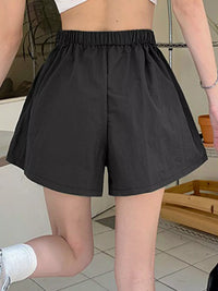 Person wearing black shorts in an indoor setting