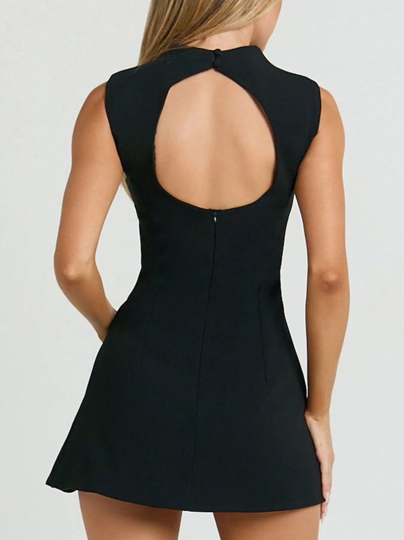 Black dress with open back on a plain background