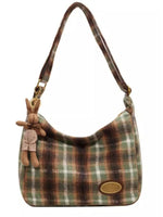 Plaid handbag with a rabbit keychain on a white background