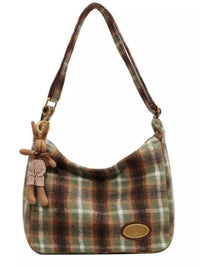 Plaid handbag with a rabbit keychain on a white background