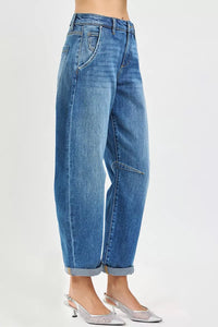 Blue jeans worn by a person on a white background