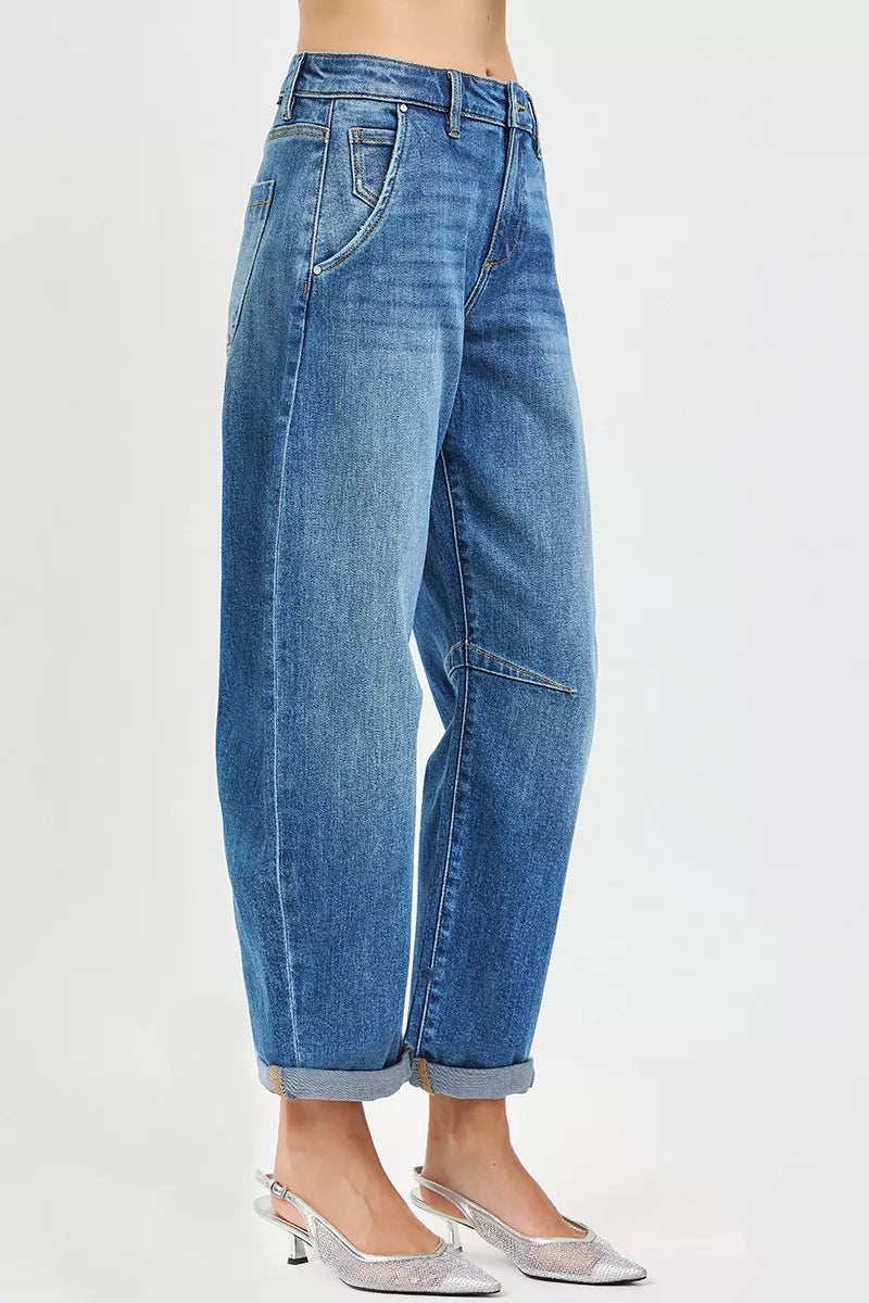 Blue jeans worn by a person on a white background