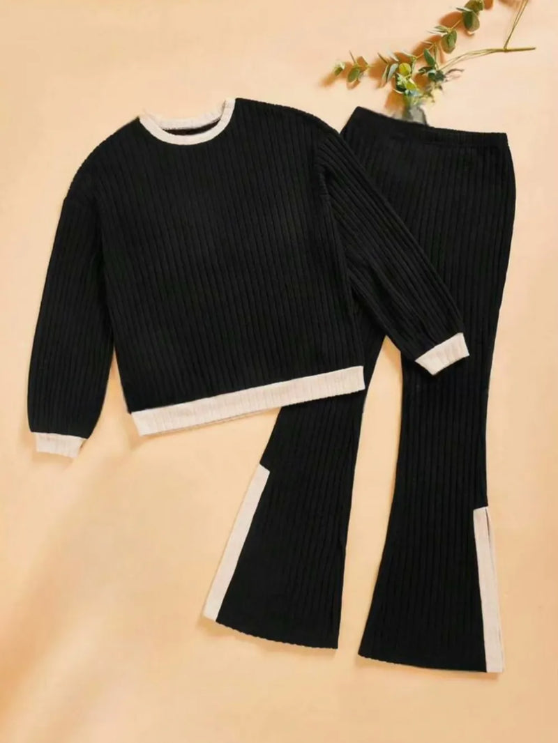 Black ribbed sweater and pants set on a beige background