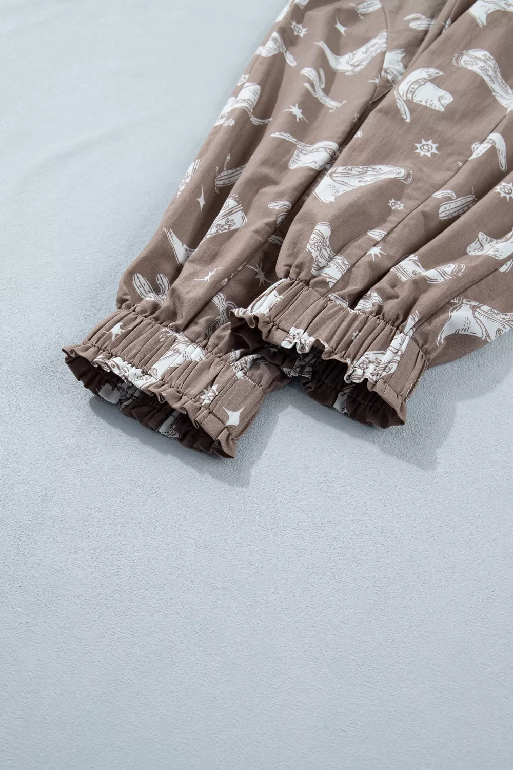Brown fabric with white patterns on a light blue background