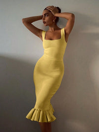Woman wearing a yellow dress with a plain background