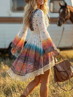 Woman in a colorful dress with fringe walking in a field with a horse in the background.