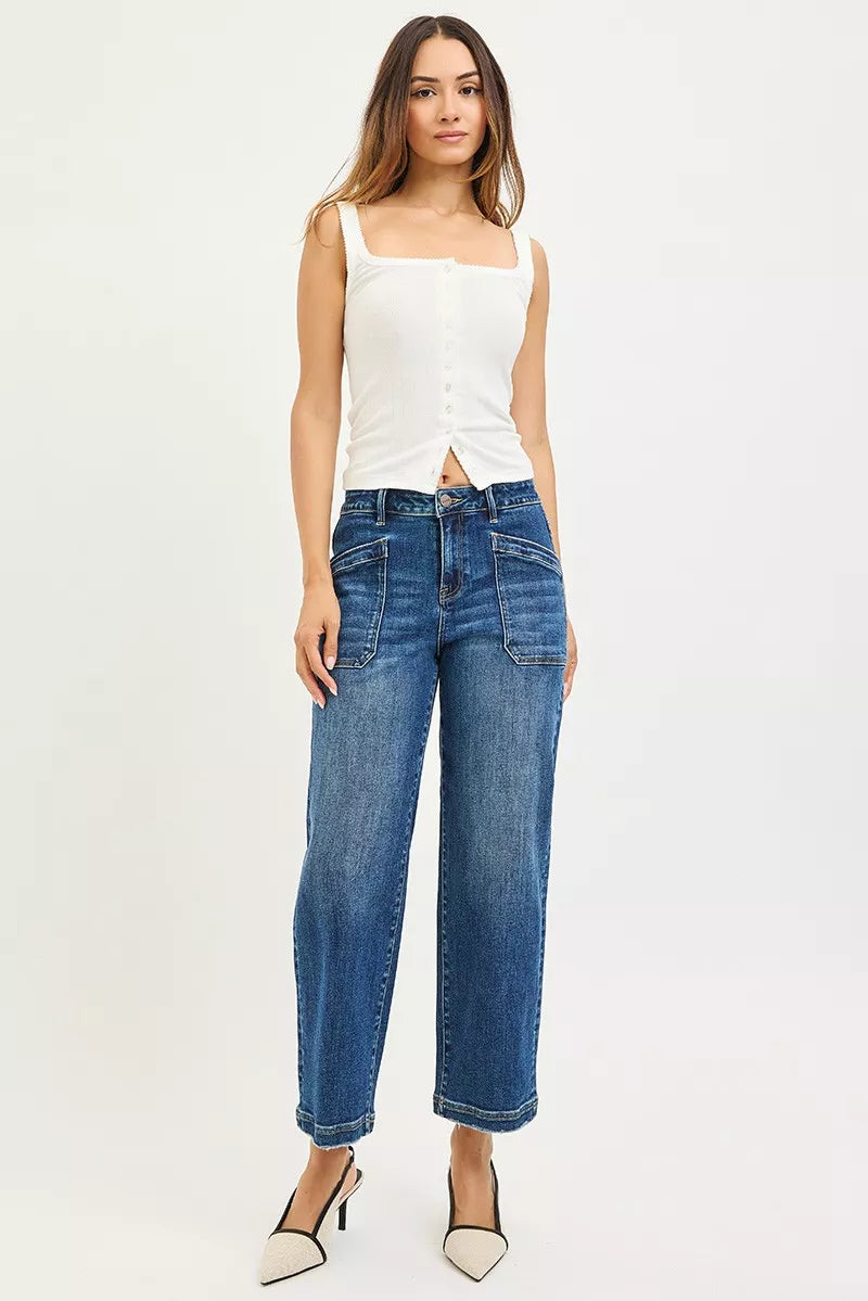 Woman wearing a white top and blue jeans on a white background