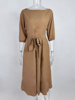 Brown dress on a mannequin against a white background