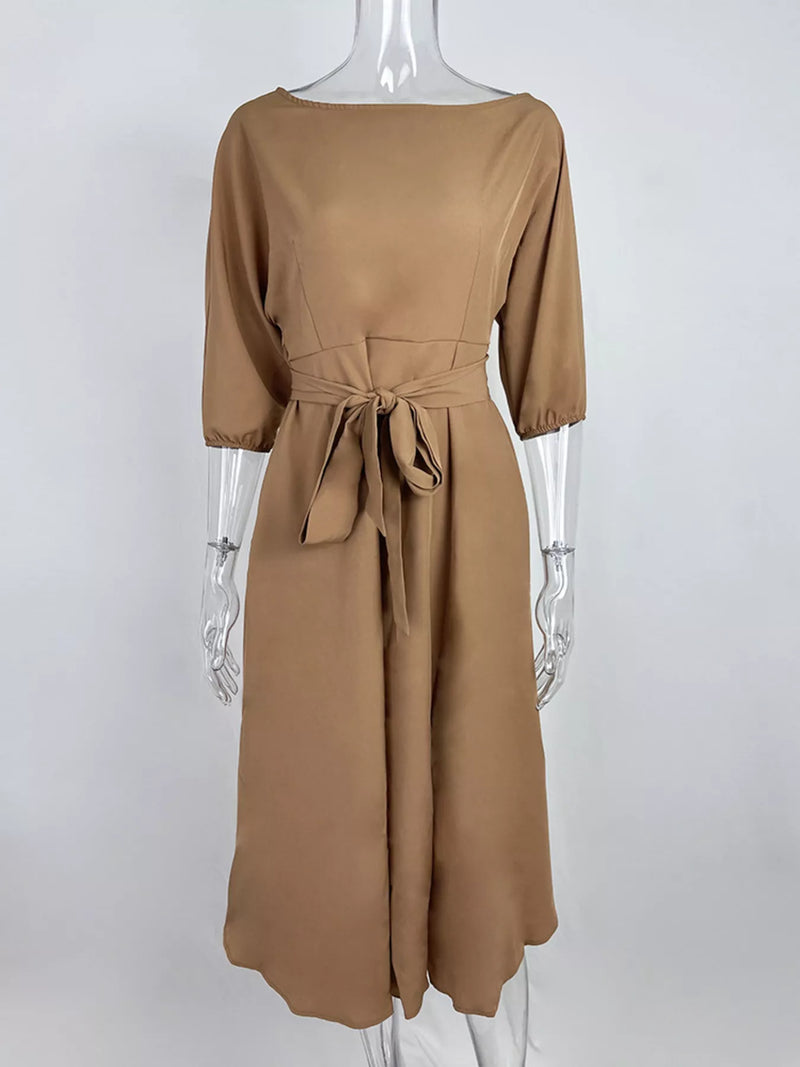 Brown dress on a mannequin against a white background