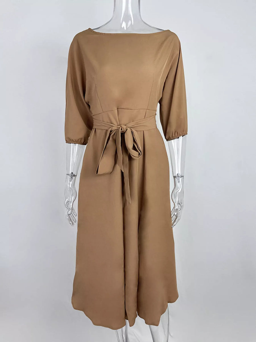Brown dress on a mannequin against a white background