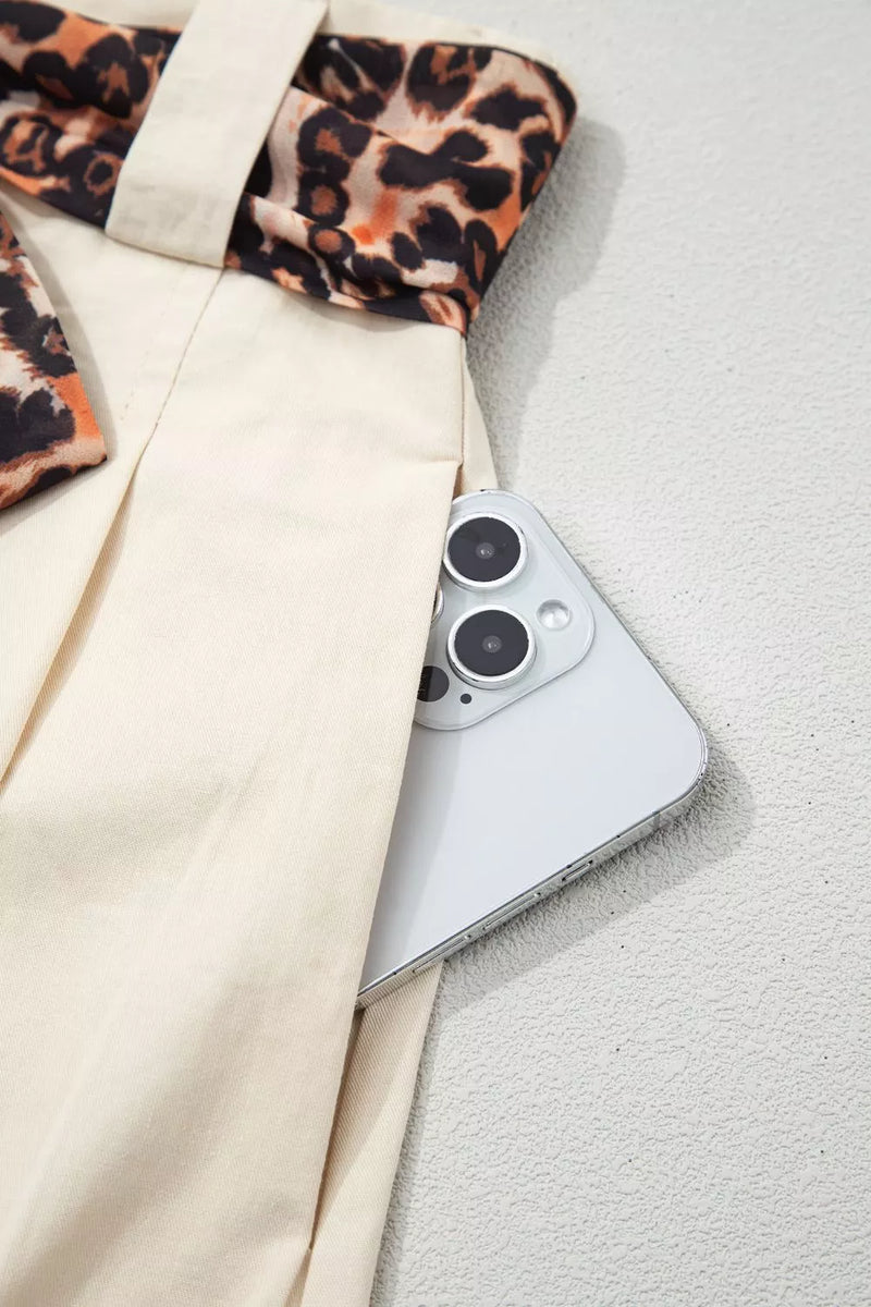 Smartphone on a textured surface with a patterned fabric item in the background