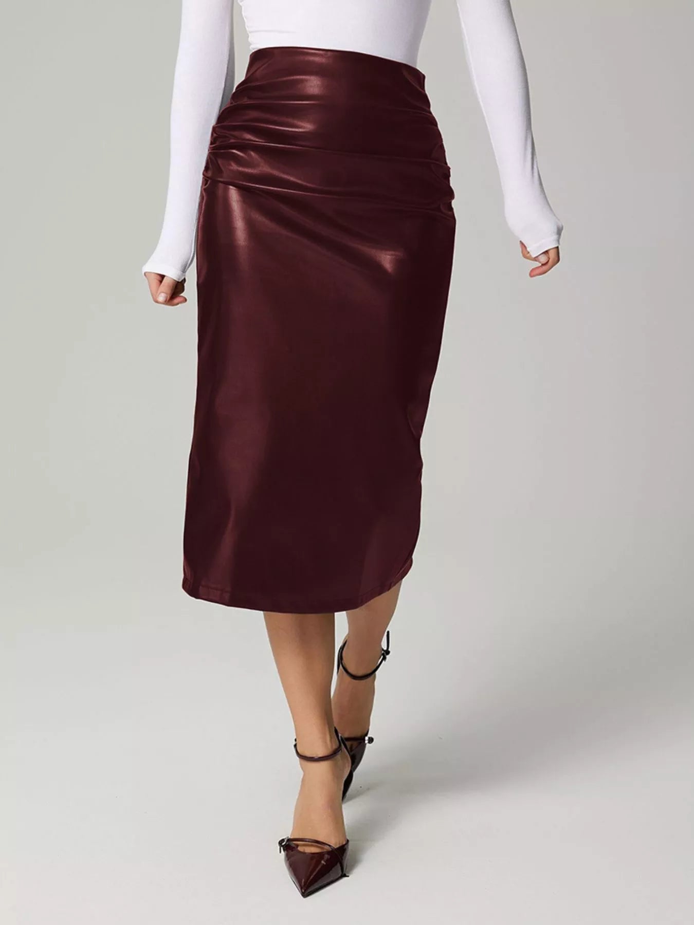 Burgundy satin skirt worn by a person on a plain background