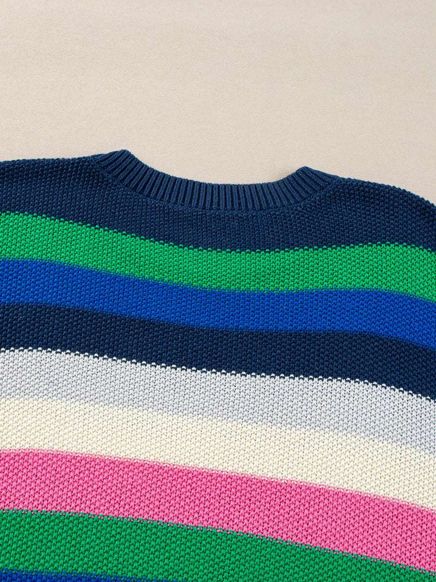 Close-up of a sweater with colorful horizontal stripes on a beige background