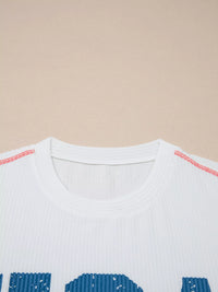 Close-up of a white shirt with blue text on a beige background