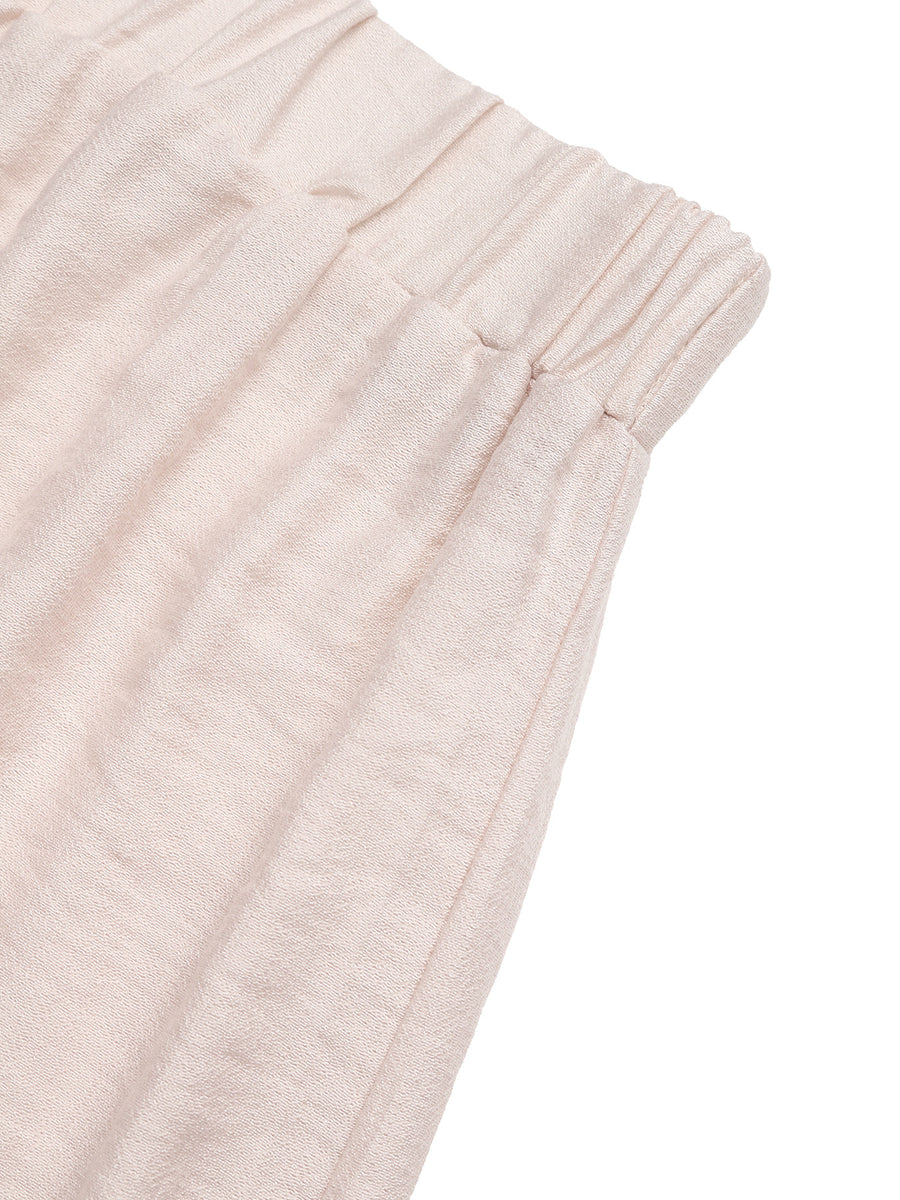 Close-up of light pink textured fabric on a white background