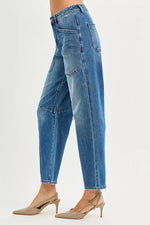Blue jeans worn by a person on a white background