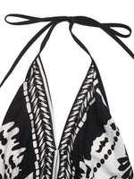 Black and white patterned top with halter neck design on a white background