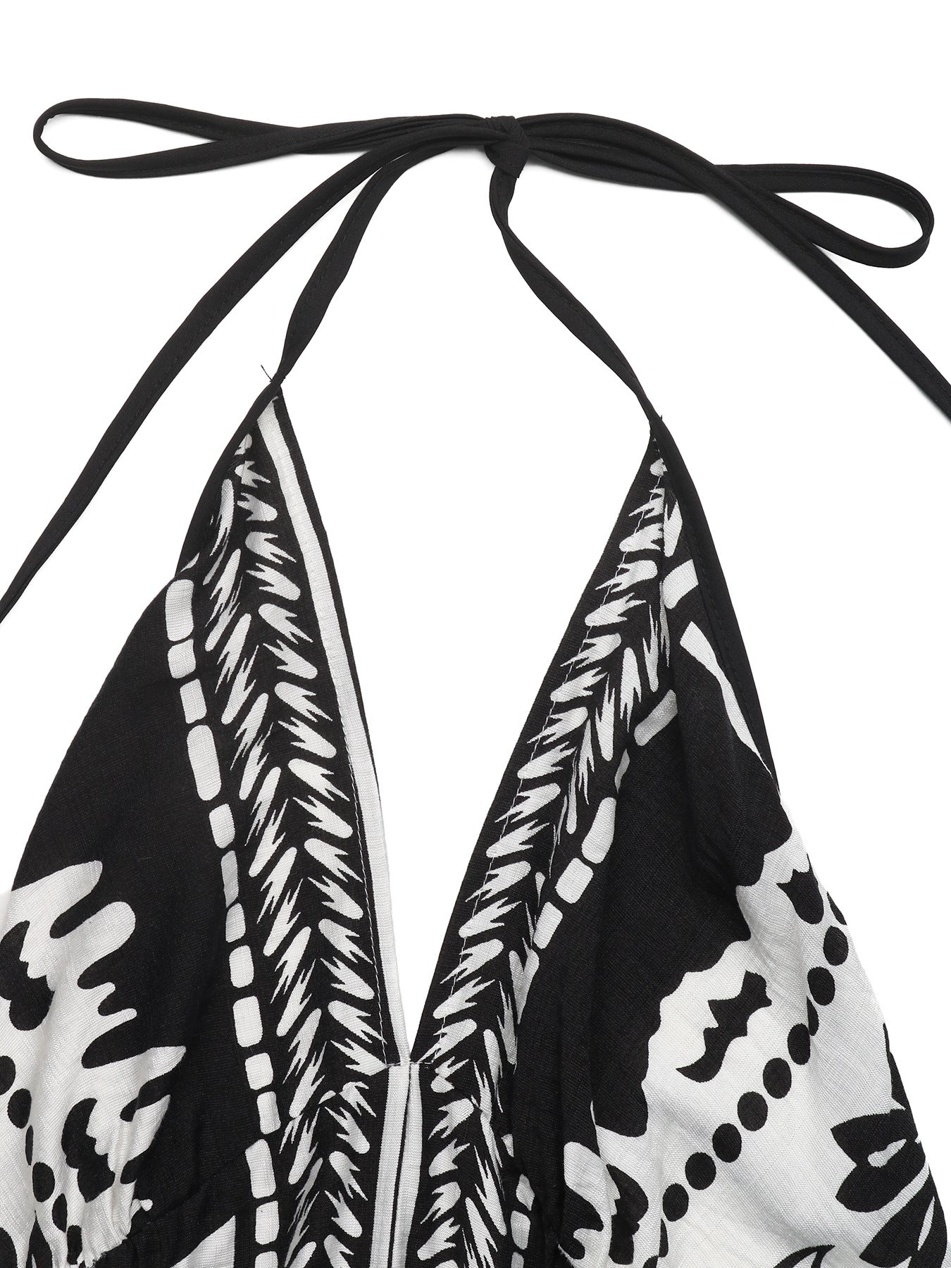 Black and white patterned top with halter neck design on a white background