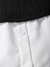 Close-up of a white shirt with a button and black collar.