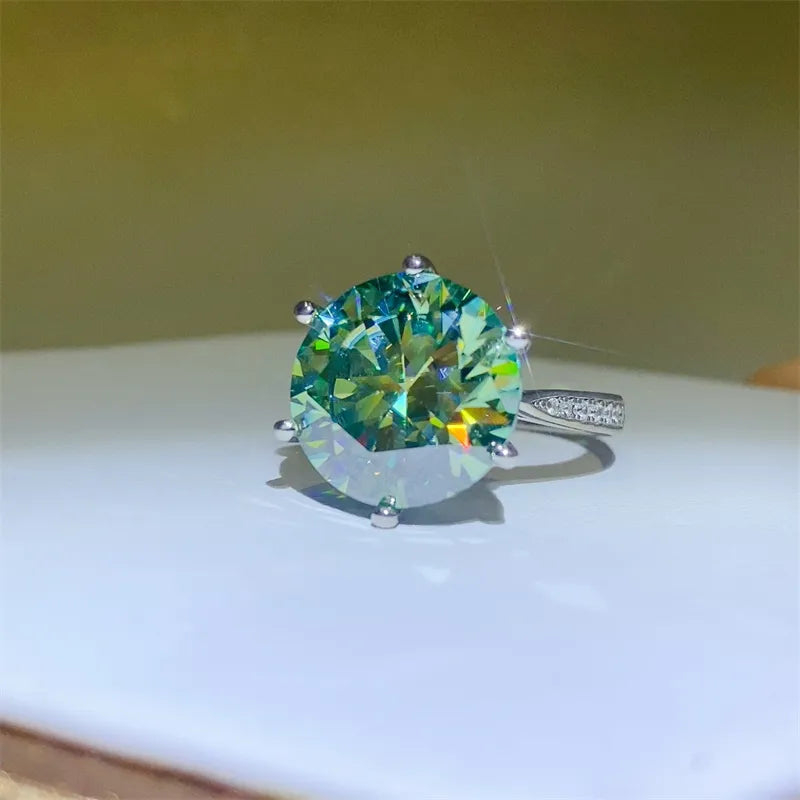 Ring with a large green gemstone on a white surface