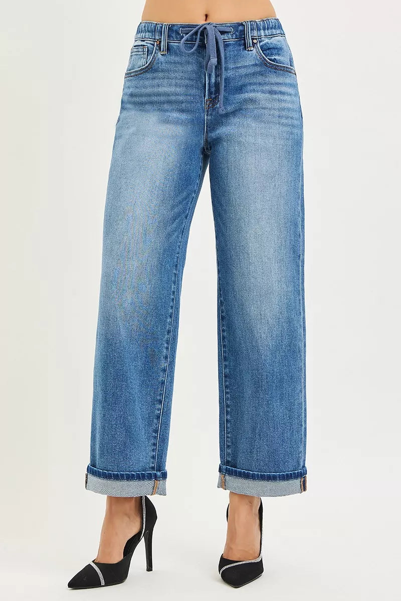 Blue jeans worn by a person on a white background