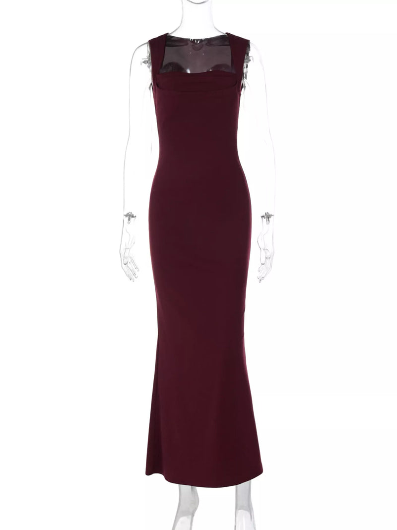 Maroon evening gown on a mannequin against a white background