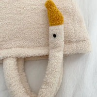Plush toy elephant with a yellow trunk on a white background