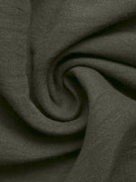 Close-up of dark green fabric with a subtle pattern