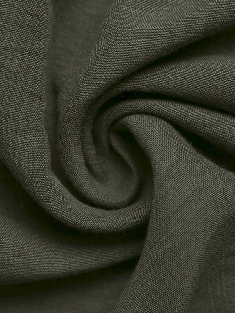 Close-up of dark green fabric with a subtle pattern