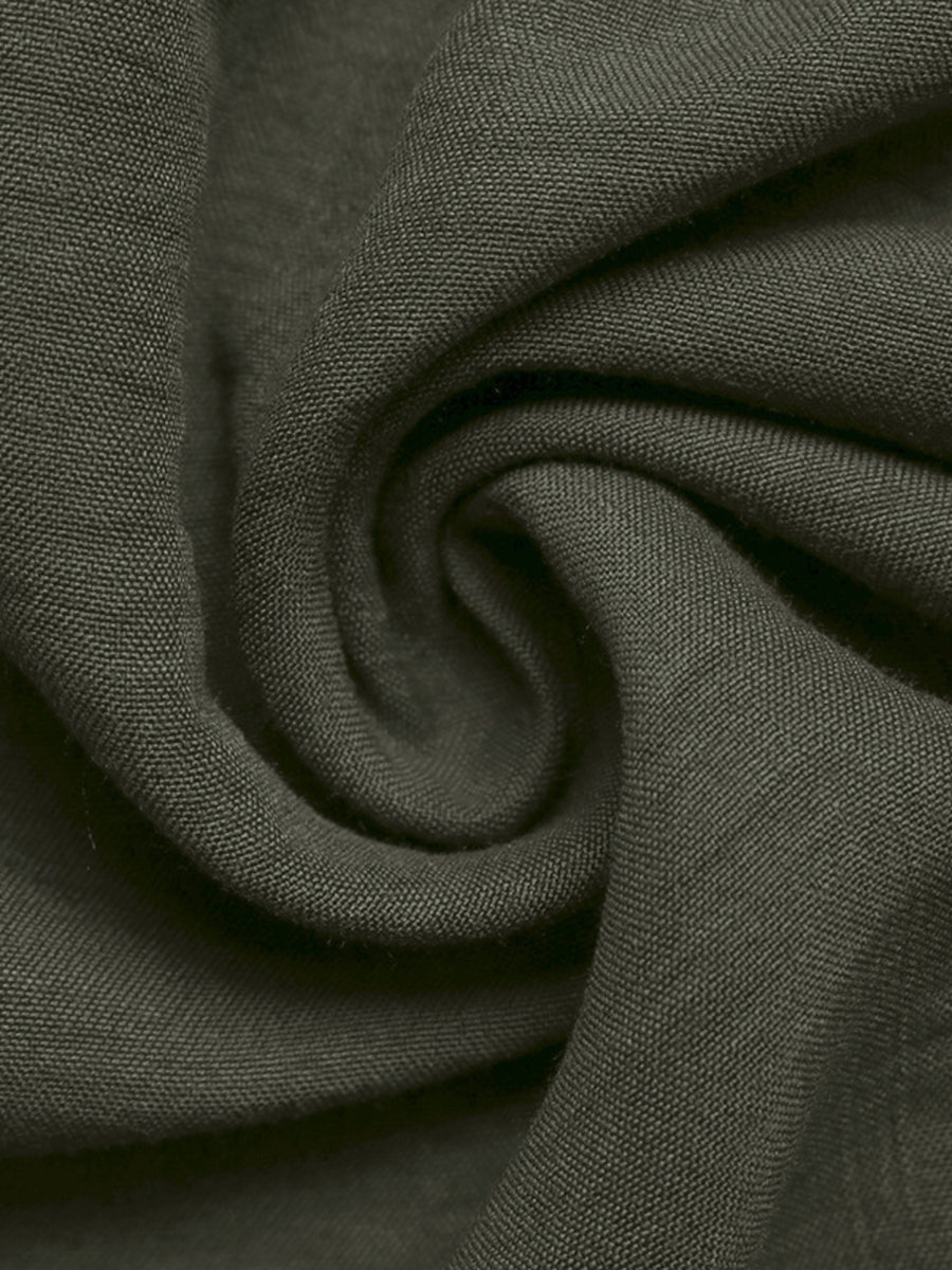 Close-up of dark green fabric with a subtle pattern