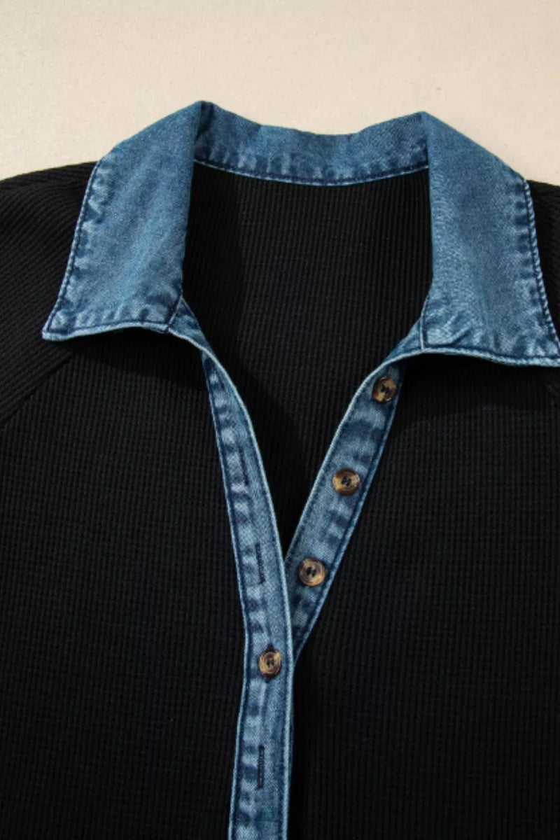 Black shirt with blue denim collar and buttons on a beige background