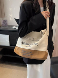 Person holding a beige and brown tote bag with text
