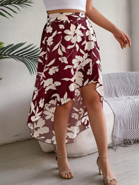 Person wearing a maroon floral skirt with a white background