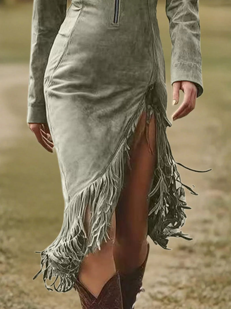 Person wearing a green suede dress with fringe details in a natural setting