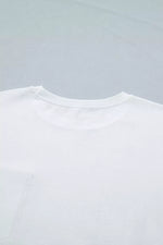 Close-up of a white t-shirt on a light gray background