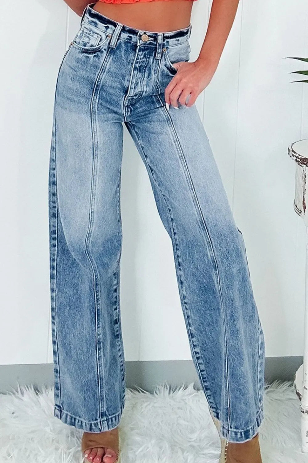 Blue jeans worn by a person on a white background